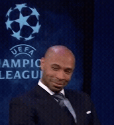 Man In Suit And Tie Smiling At UEFA League Sign GIF