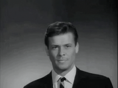 Man In Suit And Tie Smiling Black And White GIF