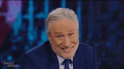 Man In Suit And Tie Smiling Funny Face Daily Show GIF