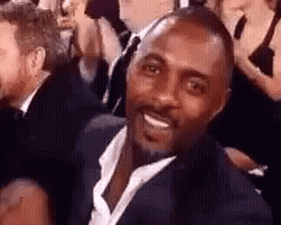 Man In Suit And Tie Smiling In Crowd GIF