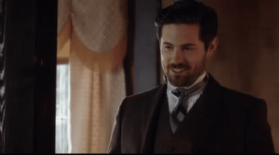 Man In Suit And Tie Smiling In Room GIF
