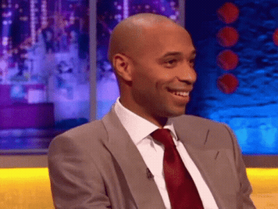 Man In Suit And Tie Smiling On Stage GIF