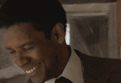 Man In Suit And Tie Smiling With Closed Eyes GIF