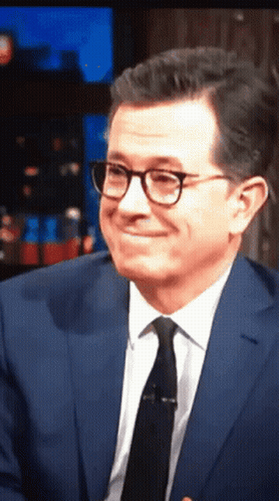Man in Suit and Tie Smiling With Glasses