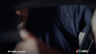 Man In Suit And Tie Smiling With NBC Logo GIF