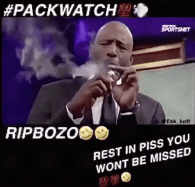 Man In Suit And Tie Smoking Cigar At Microphone GIF