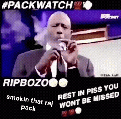 Man In Suit And Tie Smoking Into Microphone GIF
