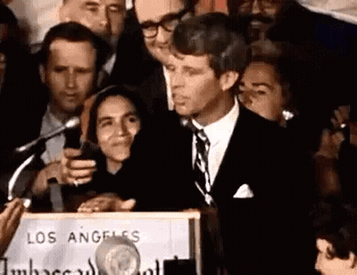 Man In Suit And Tie Speaking At Podium GIF