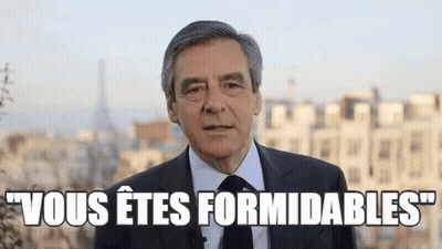 Man In Suit And Tie Speaking Before City GIF