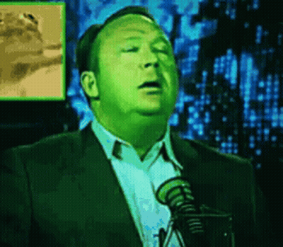 Man In Suit And Tie Speaking Into Microphone GIF