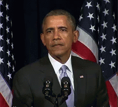 Man In Suit And Tie Speaking Into Microphone GIF