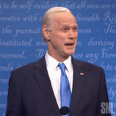 Man In Suit And Tie Speaking Microphone SNL Logo GIF