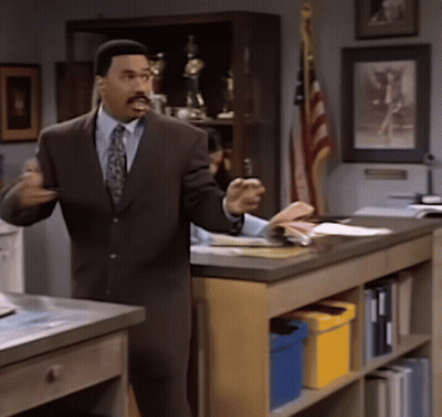 Man In Suit And Tie Standing At Counter GIF