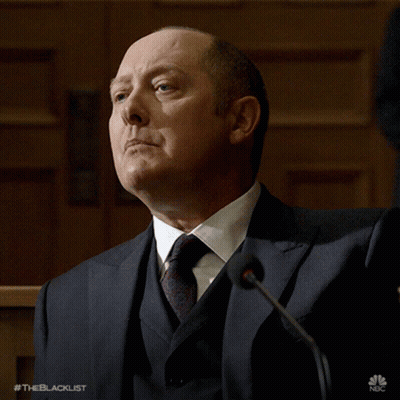 Man In Suit And Tie Standing At Microphone GIF
