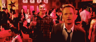 Man In Suit And Tie Standing Before Crowd At Party GIF