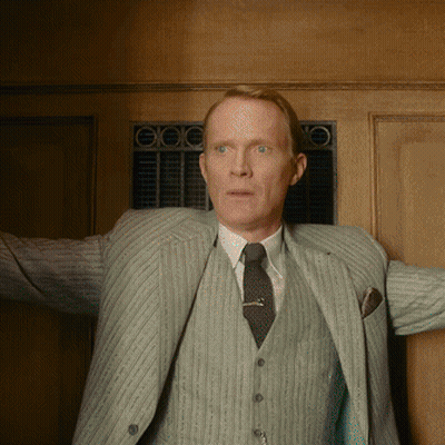 Man In Suit And Tie Standing Before Door GIF