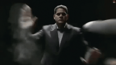 Man In Suit And Tie Standing Before Group GIF