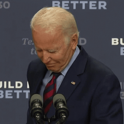 Man In Suit And Tie Standing Before Microphones GIF