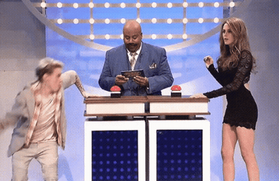 Man In Suit And Tie Standing Beside Woman In Dress GIF