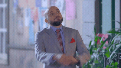 Man In Suit And Tie Standing By Window GIF