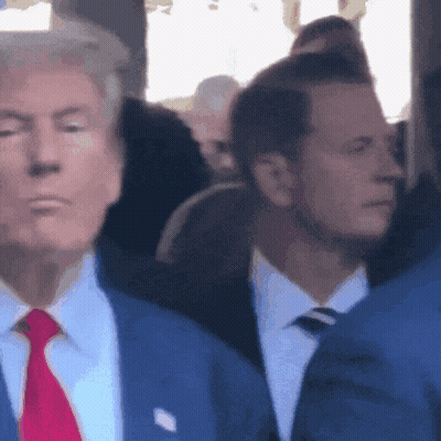 Man In Suit And Tie Standing In Crowd GIF