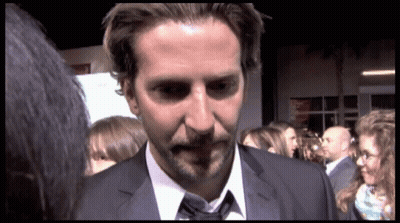 Man In Suit And Tie Standing In Crowd GIF