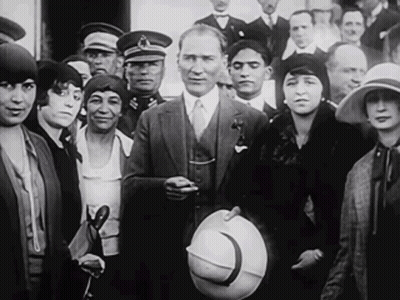 Man In Suit And Tie Standing In Crowd GIF
