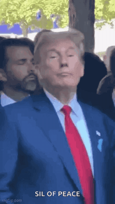 Man In Suit And Tie Standing In Crowd GIF