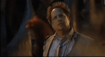 Man In Suit And Tie Standing In Dark GIF