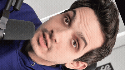 Man In Suit And Tie Standing In Dark Room GIF