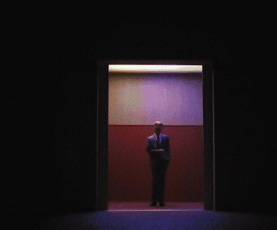 Man In Suit And Tie Standing In Elevator GIF