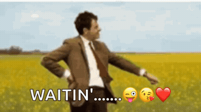 Man In Suit And Tie Standing In Field Saying Waitin GIF