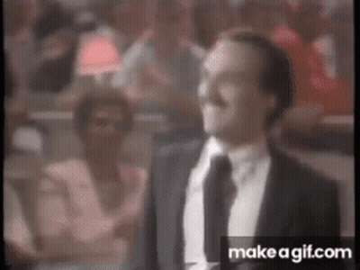 Man In Suit And Tie Standing In Front Of Crowd GIF