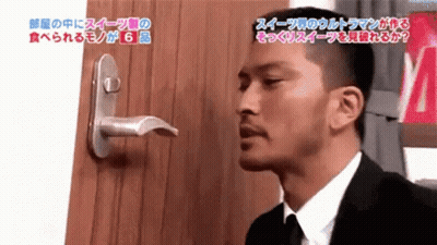 Man In Suit And Tie Standing In Front Of Door With Japanese Writing GIF