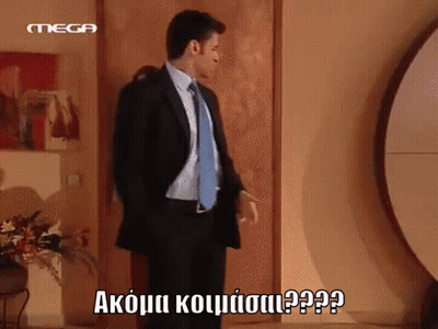 Man In Suit And Tie Standing In Front Of Door With Mega GIF