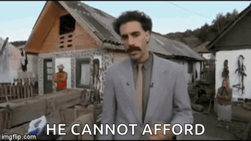 Man In Suit And Tie Standing In Front Of House GIF
