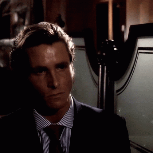 Man In Suit And Tie Standing In Front Of Mirror GIF