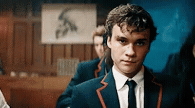 Man In Suit And Tie Standing In Front Of Sign S GIF