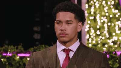 Man In Suit And Tie Standing In Front Of Tree GIF