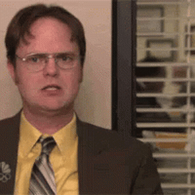 Man In Suit And Tie Standing In Front Of Window With Blinds GIF