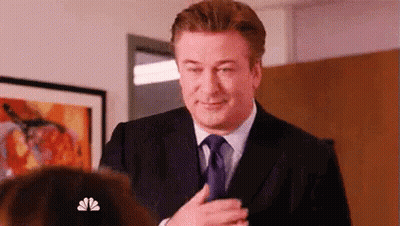 Man In Suit And Tie Standing In Front Of Woman GIF