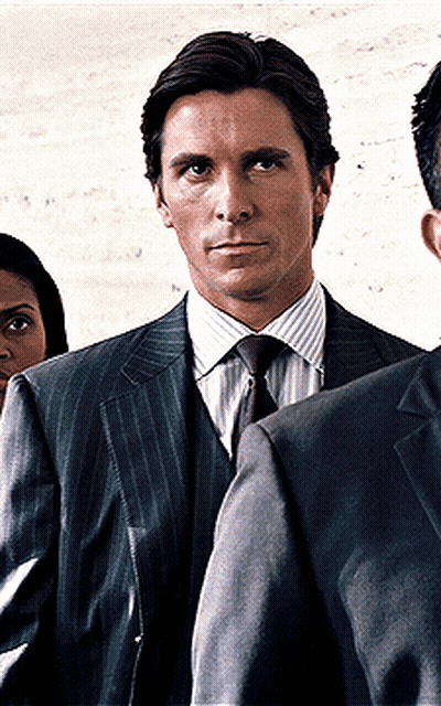 Man In Suit And Tie Standing In Front Of Woman GIF