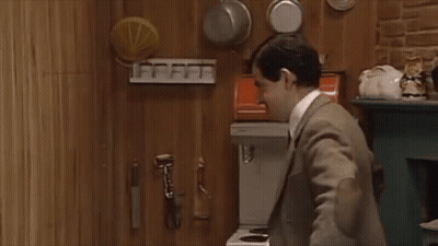 Man In Suit And Tie Standing In Kitchen GIF