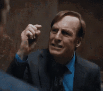 Man In Suit And Tie Standing In Room GIF
