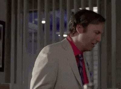 Man In Suit And Tie Standing In Room GIF