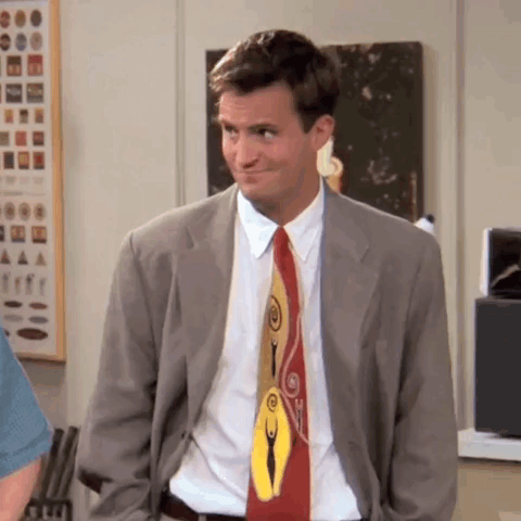 Man In Suit And Tie Standing In Room GIF