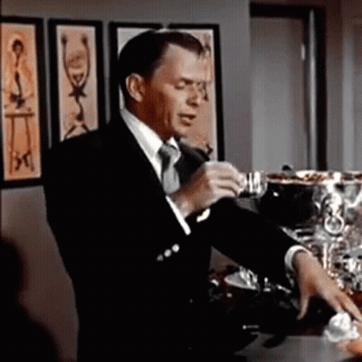 Man In Suit And Tie Standing In Room GIF