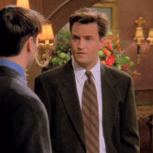 Man In Suit And Tie Standing Next To Another Man GIF