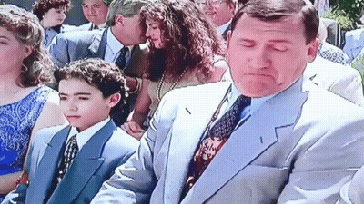 Man In Suit And Tie Standing Next To Boy In Blue Suit GIF