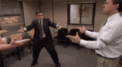 Man In Suit And Tie Standing With Other Men GIF